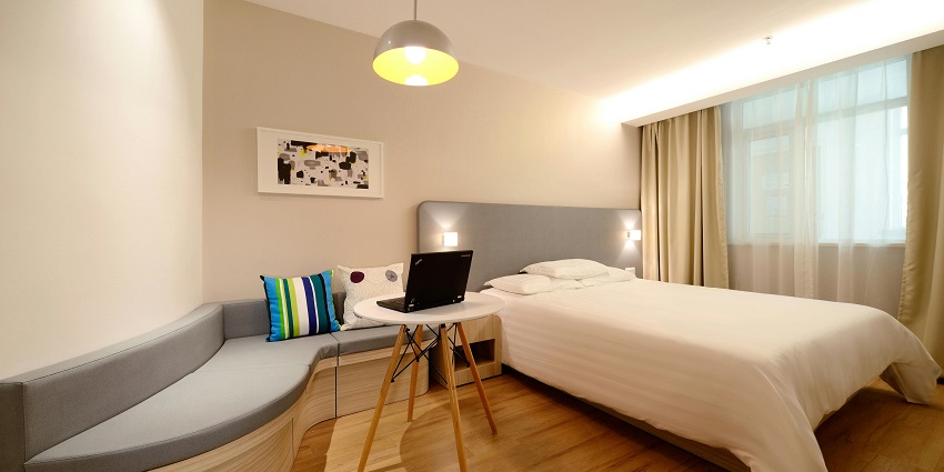 Image of a hotel room with a nice cosy bed and a lamp located in Uttarakhand