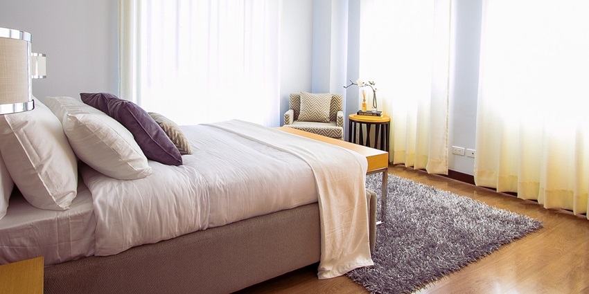 An image showing a hotel bedroom featuring sleek furniture and carefully designed interiors.