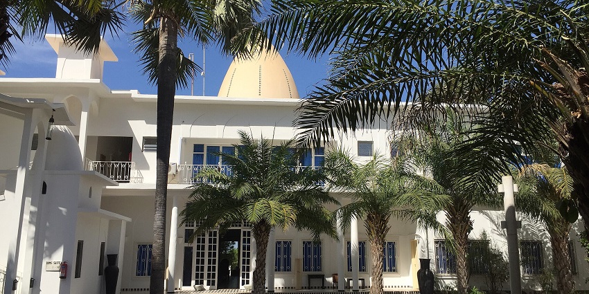 Luxurious resort in the Gambia, surrounded by lush trees and elegant architecture.