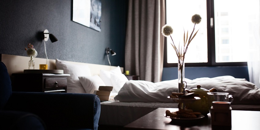 image of a spacious and luxurious hotel room with cosy beds and contemporary furnishings.