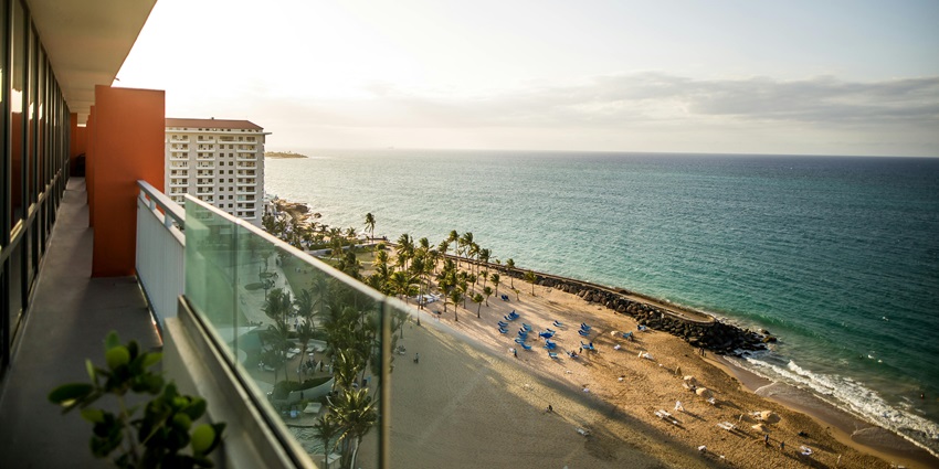 A picture of a luxury hotel room overlooking the coastline of Antalya.