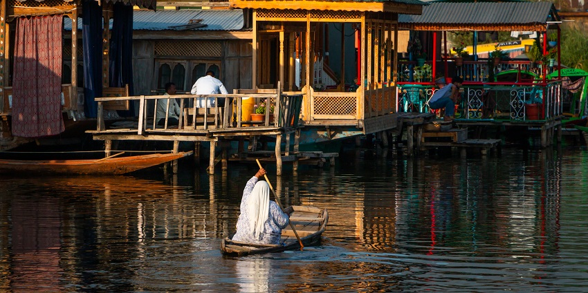 A picture of a houseboat on Dal Lake in Kashmir giving a serene view of the lake.