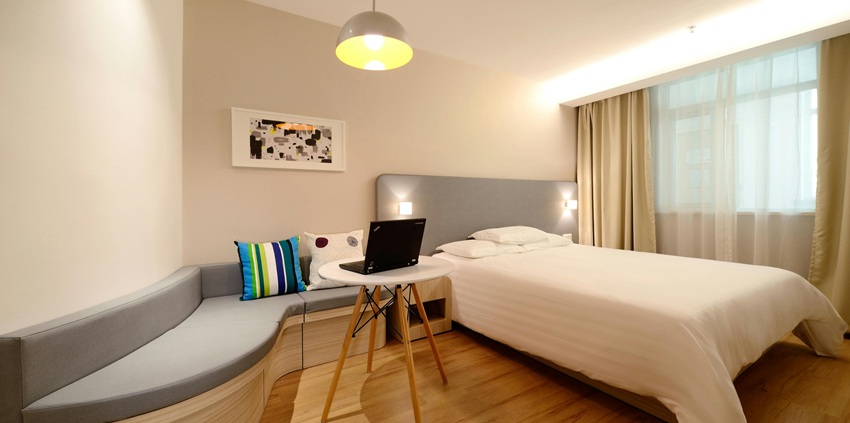 Luxurious hotel room with a cosy work area, perfect for relaxation and productivity.