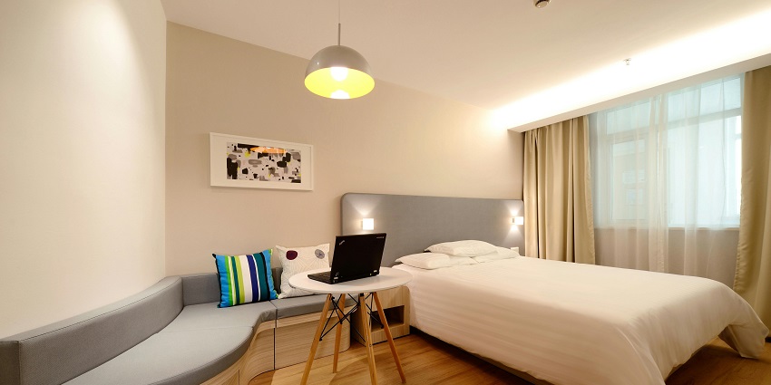 Elegant hotel bedroom featuring a cosy workspace for ultimate comfort and productivity.