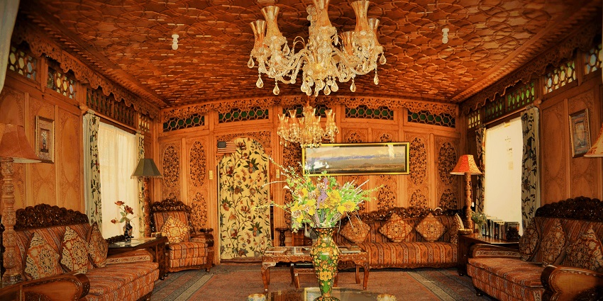 Interior of a houseboat with a flower pot, two lamps on each side and designer sofas