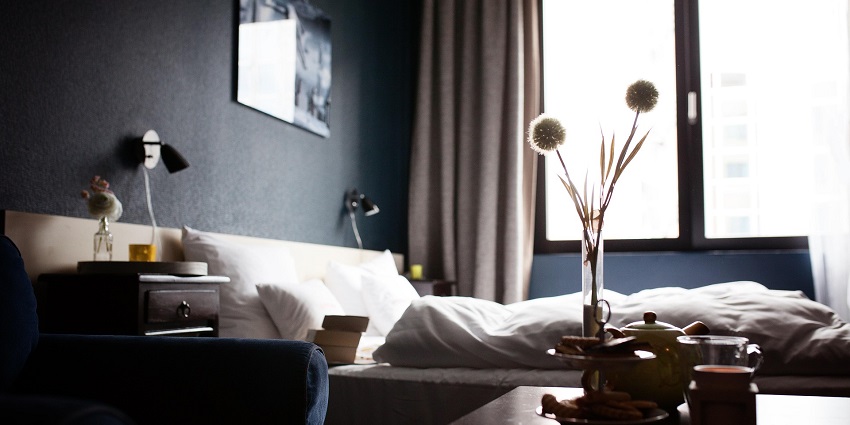 An image of a hotel room with neatly made bed similar to stays near Shirpur Water Park.