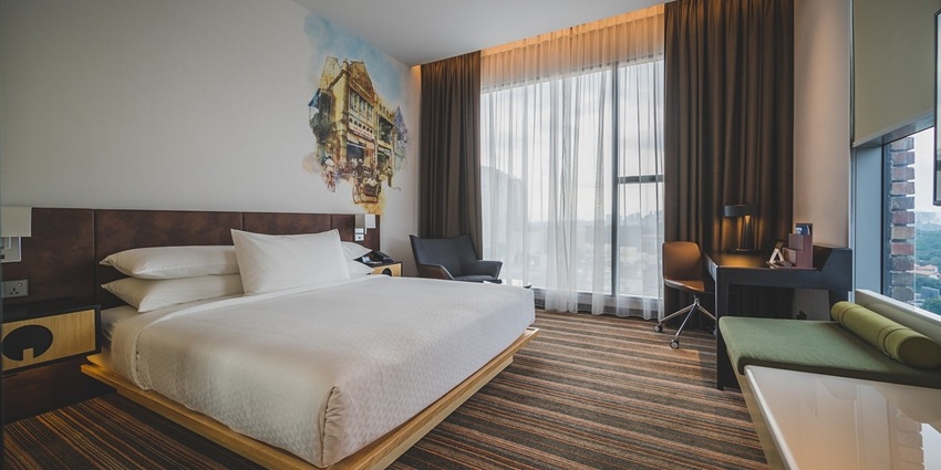 View of a bedroom with a neatly arranged bed and minimal furnishings