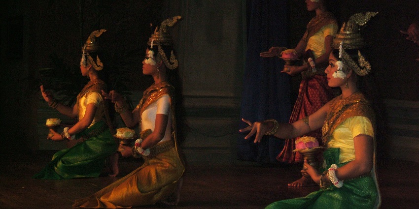 An image of four dancers in ornate, colourful attire performing the traditional Apsara dance during Pchum Ben.
