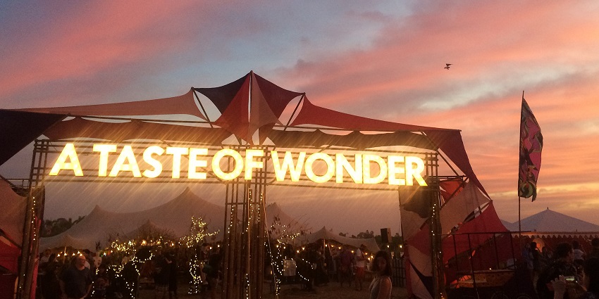 An image of vibrant art installations and stages at the Wonderfruit Festival in Pattaya, Thailand.