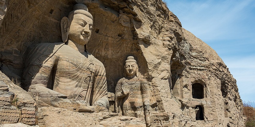 Magnificent rock-cut caves at Yungang showcase ancient Buddhist artistry and heritage.