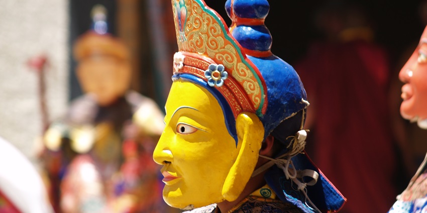 An image of the Yuru Kabgyat Festival with monks performing masked dances at Lamayuru Monastery.