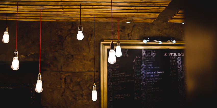 Small glowing light bulbs hanging from the wooden ceiling, displaying Dunedin nightlife.