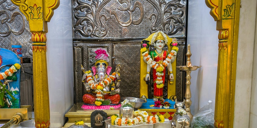 Idols of Lord Ganesha and Devi Parvati being worshipped at a Hindu temple