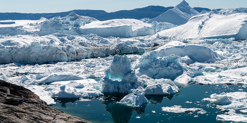 A breathtaking UNESCO site with massive icebergs floating in deep blue Arctic waters.