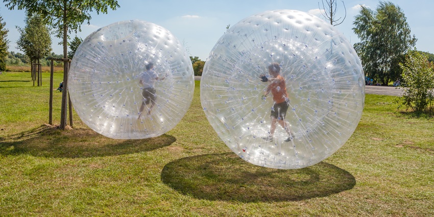 An image of people zorbing, one of the best things to do in Rotorua, New Zealand.