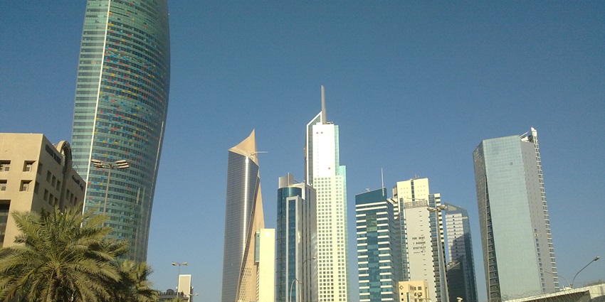 Kuwait City skyline featuring major modern skyscrapers and urban architecture.