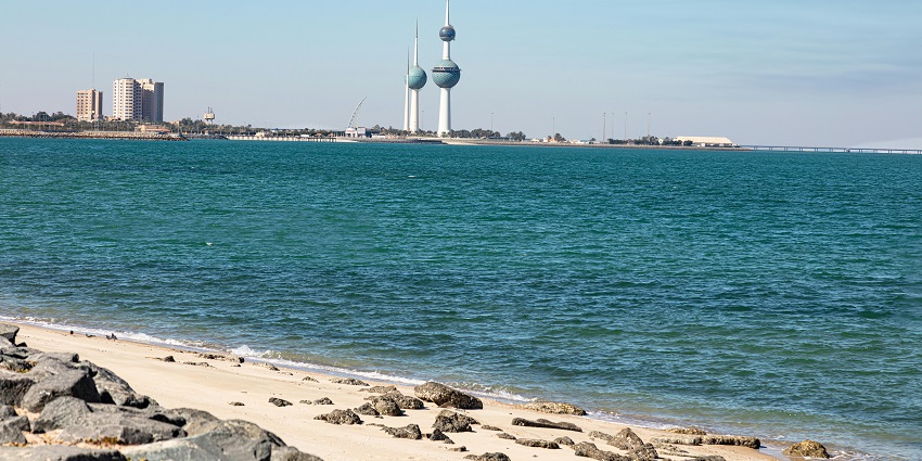 An image of stunning clear blue waters and sandy shores in Al Kout Beach in Kuwait.
