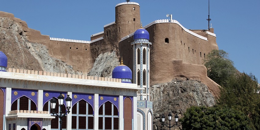 Al Mirani Fort rising above coastal Al Khor Mosque under blue sky and sea
