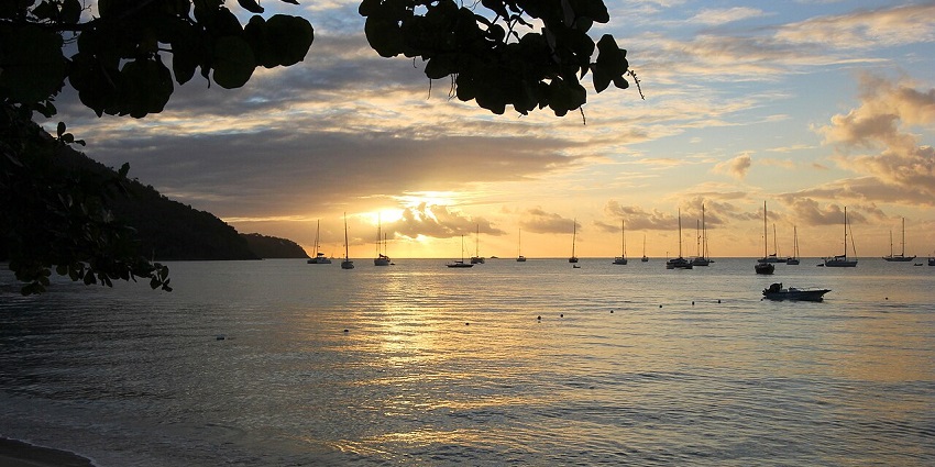 Golden hues over Almond Bay Providencia, where calm waters meet untouched Caribbean beauty.
