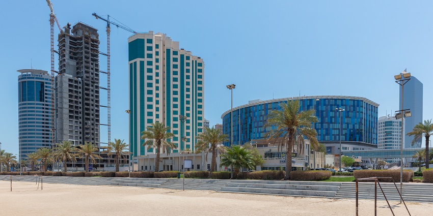 An image showing a wide cityscape of Kuwait with modern high-rise buildings.