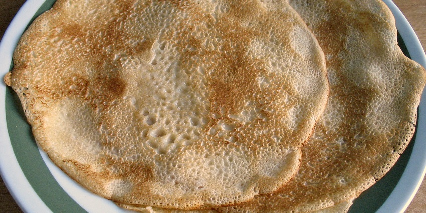 A stack of thin Blini, golden pancakes with caviar and sour cream, the best food in Russia.