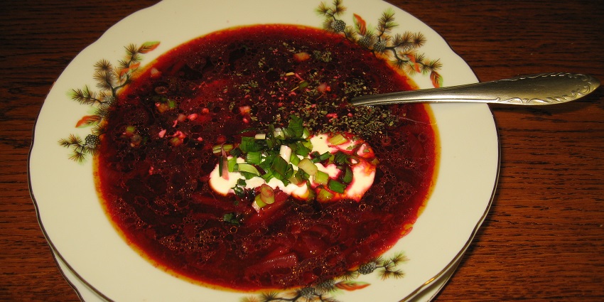 A bowl of deep-red Borscht, beetroot soup with sour cream, the most famous food in Russia.