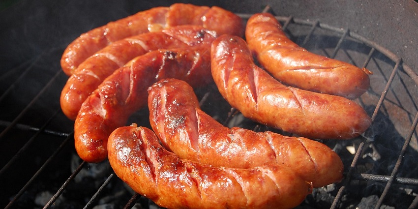 Grilled Bratwurst sausage served in a crusty bun topped with rich tomato sauce