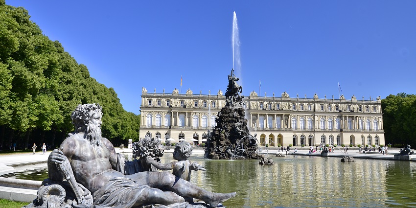 Front view of Herrenchiemsee, with a statue in front of Lake Chiemsee., one of the best places to visit near Munich.