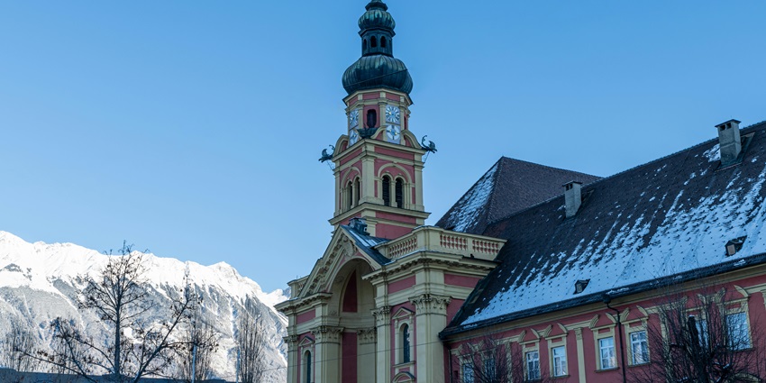 A glimpse of the City Tower featuring majestic buildings and snow-capped peaks.