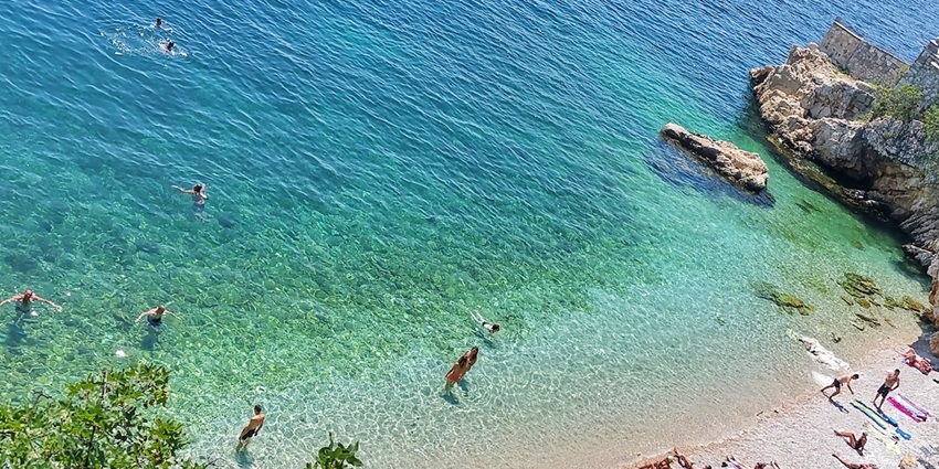 Image of Sablićevo beach where people sunbathing, playing beach games and more - things to do in Rijeka