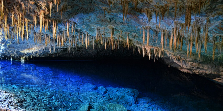 Panoramic image of the beautiful cave with water bodies and stalagmites