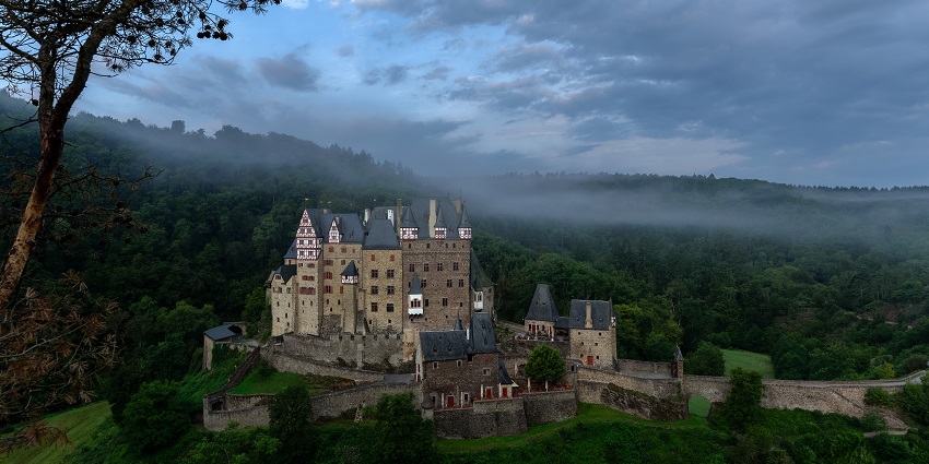 Burg Eltz in the early morning light with soft fog surrounding the castle looking stunning