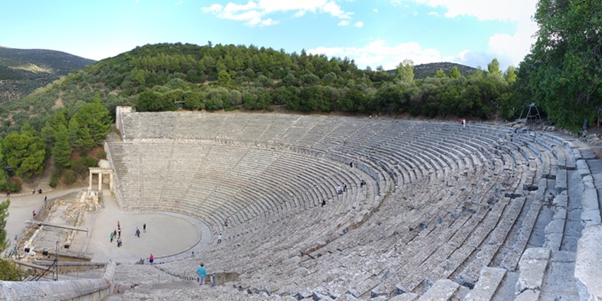 Tourists exploring the ruined ancient amphitheatre in Epidaurus, an old site near Athens.