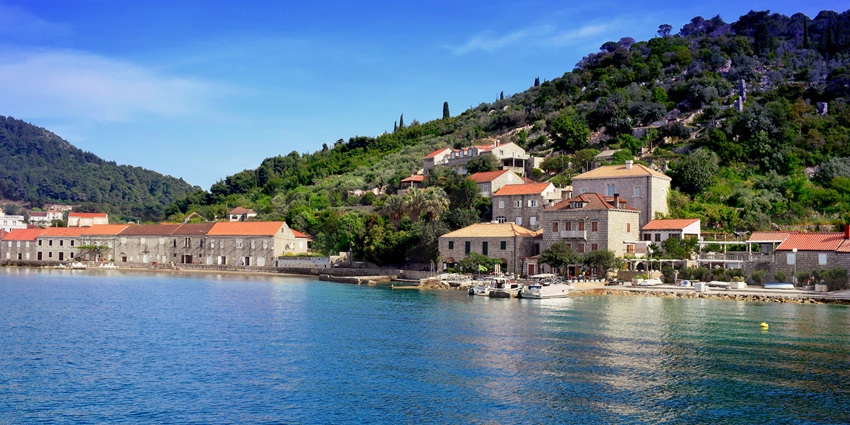 Idyllic view across the hills, water body and house on the shore of Lopud Island