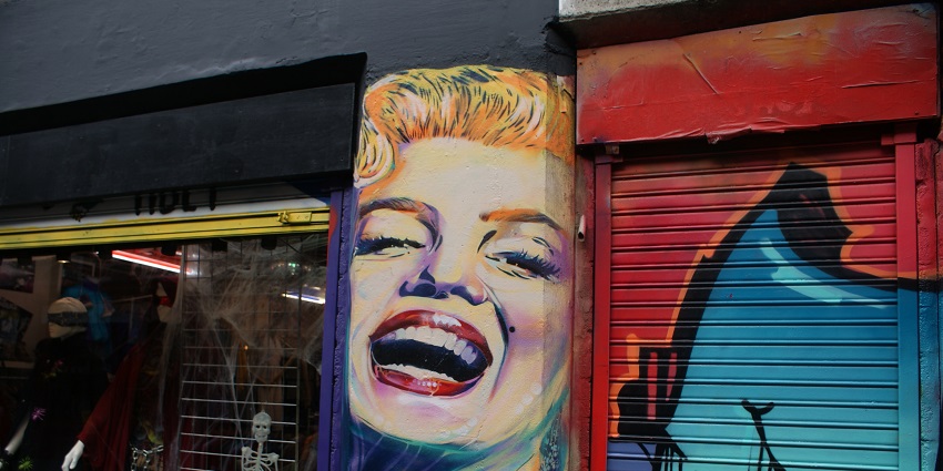 Street art of Marilyn Monroe on Cheshire Street, showcasing vibrant colours and pop imagery.
