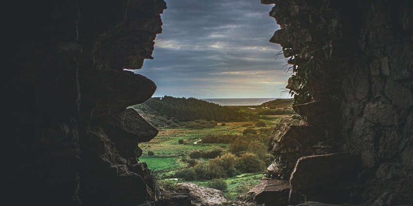 An image of Nefo Cave, surrounded by dense jungle in Chuuk Lagoon.