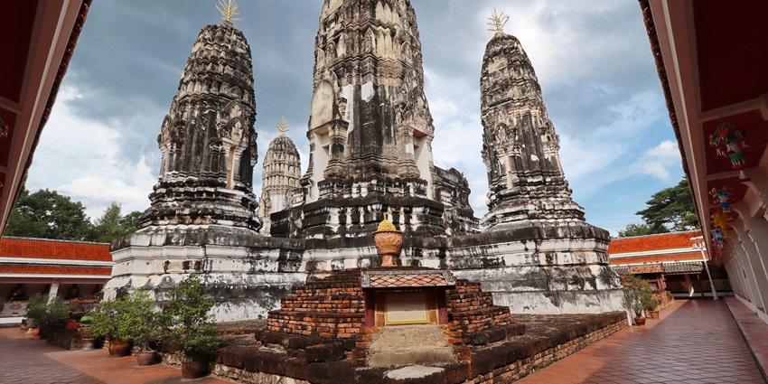 Admire the traditional architectural designs and ancient ruins at Wat Mahathat.