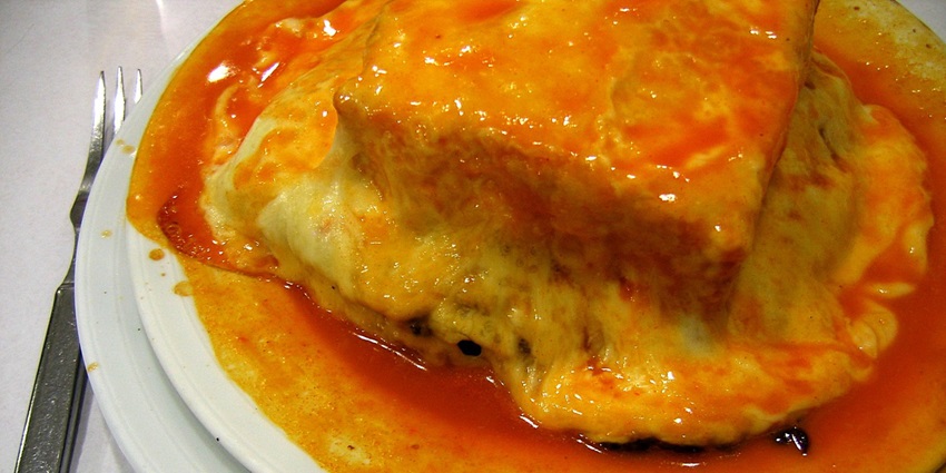 An image of Francesinha, a heavy sandwich with meat among the best food in Portugal.