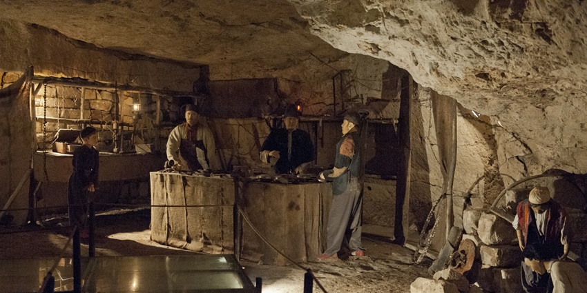 A picture of a section of a war museum with sculptures depicting war planning and activities