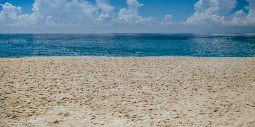 Peaceful ocean view under clear daylight skies with gentle waves and distant horizon line, one of the best places to visit in the Isles of Scilly.