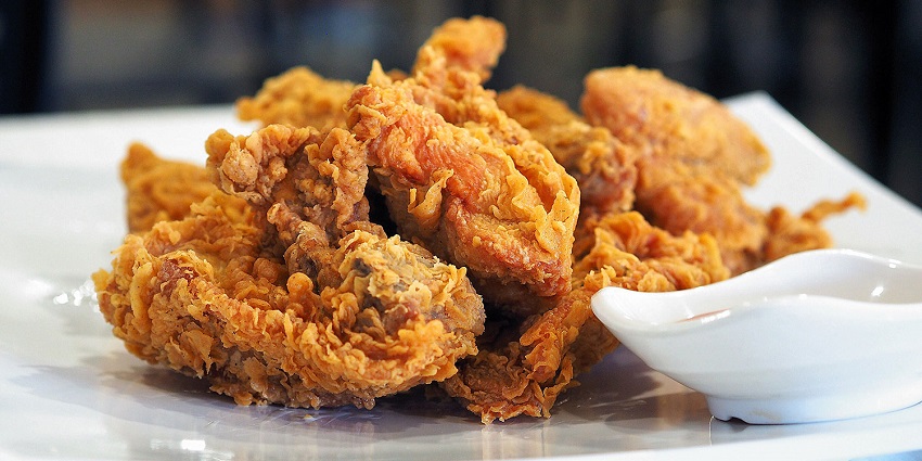 Crispy Korean fried chicken glazed with spicy-sweet sauce served hot and golden brown