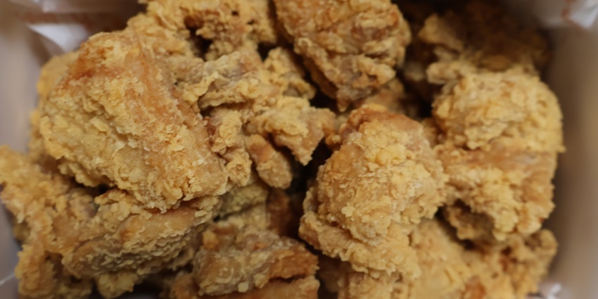 A close-up view of mouth-watering Korean Fried Chicken, a famous street food in Toronto, Canada.