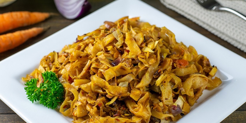A sizzling plate of famous food in Sri Lanka, Kottu Roti, a chopped roti with vegetables and meat.
