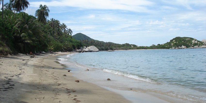 One of the best places to visit in Capurgana is this beautiful beach with lush surroundings and blue waters