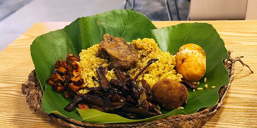 A banana leaf-wrapped meal of Lamprais, the best non-veg food in Sri Lanka, with rice and meat.