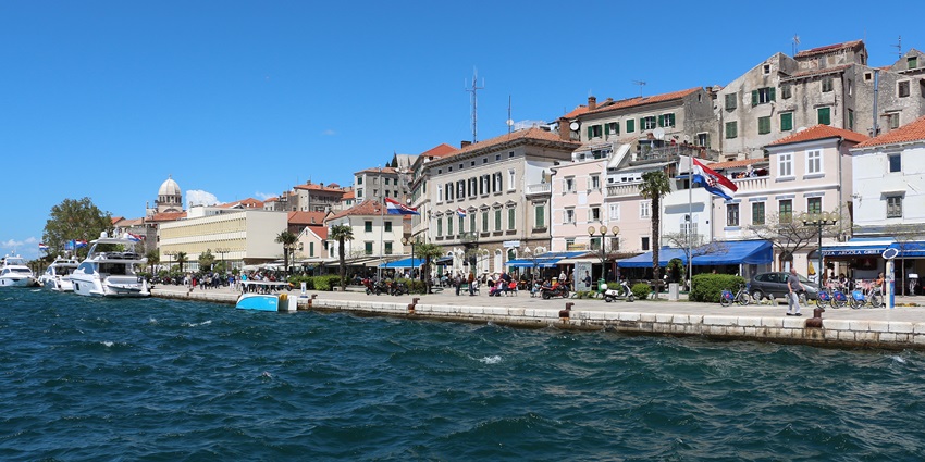An image showing a view of Sibenik, featuring its historic buildings and coastal landscape.