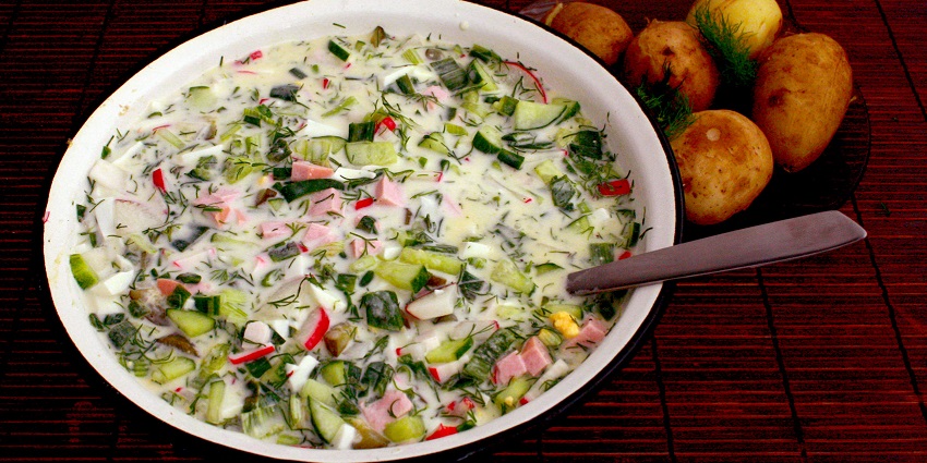 A bowl of Okroshka, a cold refreshing summer soup with vegetables and kefir.
