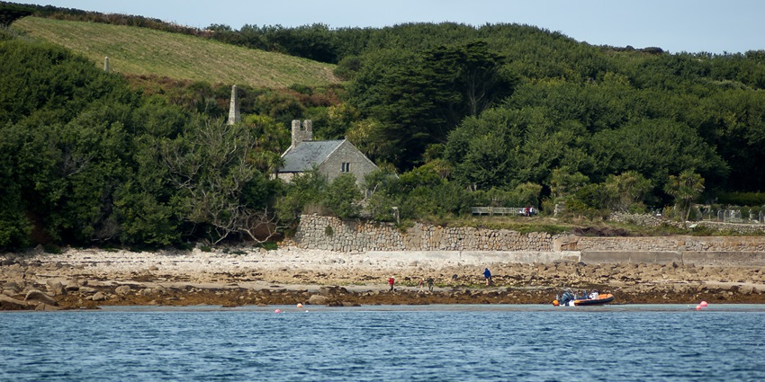 St Mary’s Church overlooking Old Town Bay on the Isles of Scilly, surrounded by coastal greenery, one of the best places to visit in the Isles of Scilly.