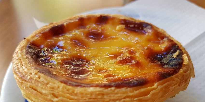 An image of Pastel de Nata, a small egg custard tart among the famous food in Portugal.
