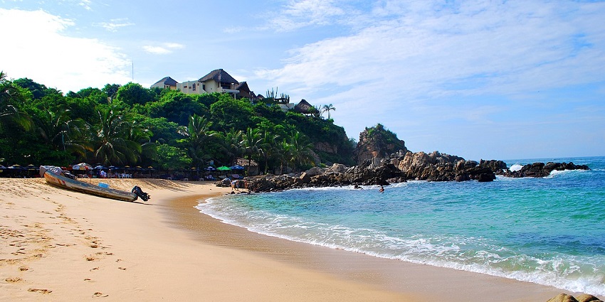 Manchineel Bay is a haven of white powdery sand, swaying palm trees, and crystal-clear water.